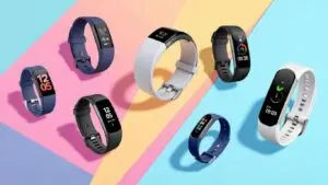 Colorful fitness trackers on a vibrant background.