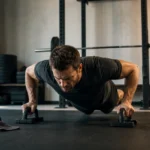 Man doing strict pushups with handles in a modern home gym during a high-rep challenge